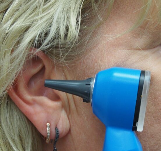 A doctor is using an otoscope to check ear.